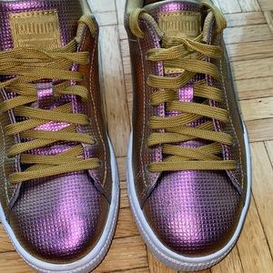 Iridescent purple and gold Puma low top sneakers with gold laces.